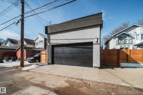 Detached garage featuring a modern pitched roofline and a dark overhead door - 9625 101 Street, Edmonton, AB - Outdoor