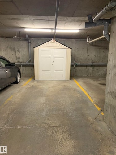 Dedicated parking space with a personal storage shed featuring double doors and a gabled roof - 307 6084 Stanton Drive, Edmonton, AB - Indoor Photo Showing Garage