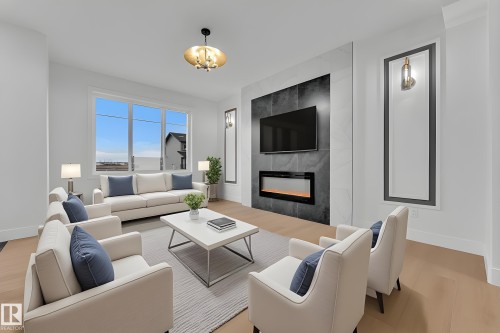 Living area featuring light wood-finish flooring and white walls - 456 Crystal Creek Link, Leduc, AB - Indoor Photo Showing Living Room With Fireplace