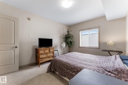 The property features a room with light-colored walls and carpeted flooring - 