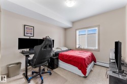 This room features a window with horizontal blinds, neutral wall tones, and carpeted flooring - 