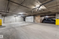 The property features an underground parking area with concrete walls and flooring, and exposed piping on the ceiling - 