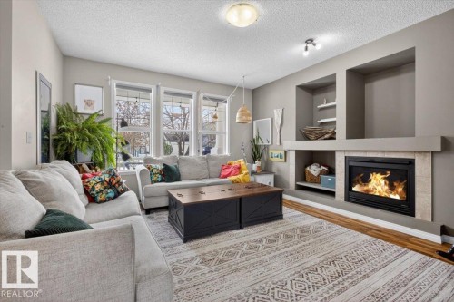 7704 16 Avenue, Edmonton, AB - Indoor Photo Showing Living Room With Fireplace