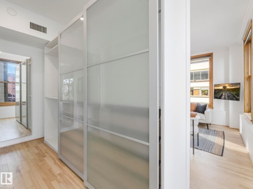 This property features hardwood flooring, white walls, and a recessed ceiling vent - 807 10134 100 Street, Edmonton, AB - Indoor