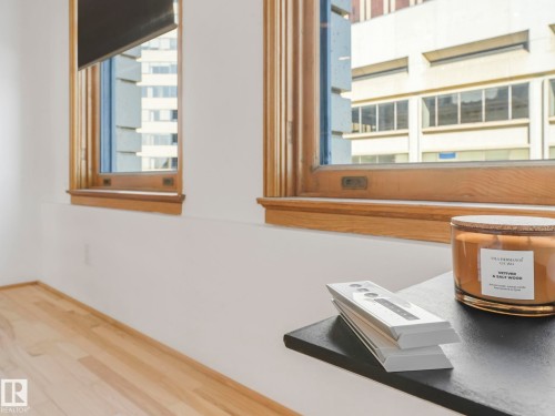The room features light wood flooring and windows with wood frames - 807 10134 100 Street, Edmonton, AB - Indoor Photo Showing Other Room