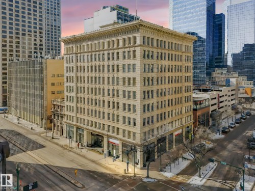 This property is a multi-story building featuring numerous windows across its facade and street-level access - 807 10134 100 Street, Edmonton, AB - Outdoor