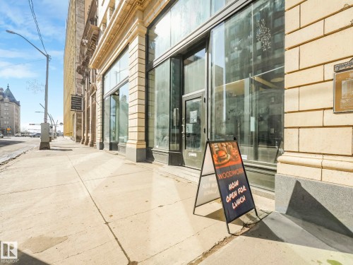 The property features a storefront with large display windows and a prominent entrance - 807 10134 100 Street, Edmonton, AB - Outdoor