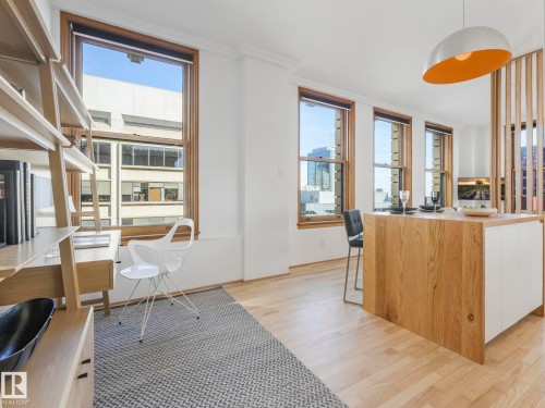 The property features light wood flooring throughout, with large windows providing natural light - 807 10134 100 Street, Edmonton, AB - Indoor Photo Showing Office