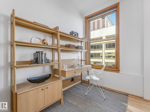 This room features a window with natural wood trim, providing natural light - 807 10134 100 Street, Edmonton, AB - Indoor Photo Showing Office
