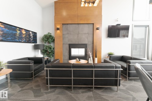 Social Area  Fireplace  Pool Table  Dart Boards and Coffee Station  Exercise Room  Banquet Room  Spacious Kitchenette  Flex Space For Meetings, Crafts, Card Tournaments - #207 50 Heatherglen Dr, Spruce Grove, AB - Indoor With Fireplace