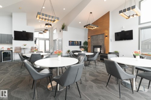 #207 50 Heatherglen Dr, Spruce Grove, AB - Indoor Photo Showing Dining Room With Fireplace