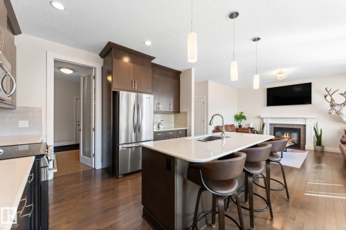 8 Spring Bay, Spruce Grove, AB - Indoor Photo Showing Kitchen With Fireplace With Upgraded Kitchen