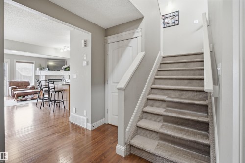 Carpeted staircase with white handrails and trim - 3533 11 Street, Edmonton, AB - Indoor Photo Showing Other Room