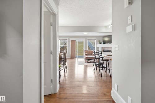 Bright interior with wood-finish flooring extending into the main living area - 3533 11 Street, Edmonton, AB - Indoor Photo Showing Other Room