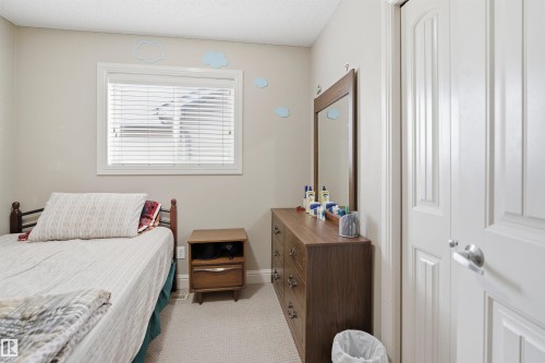 Neutral tone walls with an accent window featuring horizontal blinds - 3533 11 Street, Edmonton, AB - Indoor Photo Showing Bedroom