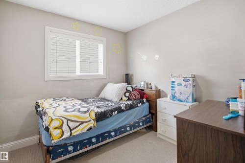 Neutral wall paint with textured ceiling - 3533 11 Street, Edmonton, AB - Indoor Photo Showing Bedroom