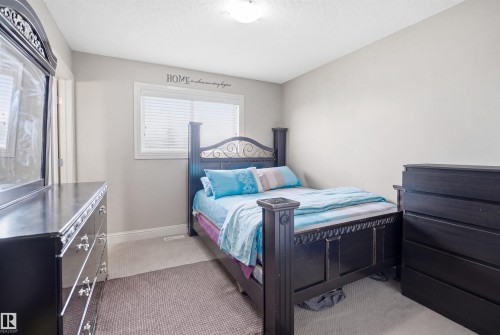 Soft gray walls complement the window with horizontal blinds, providing natural light - 3533 11 Street, Edmonton, AB - Indoor Photo Showing Bedroom