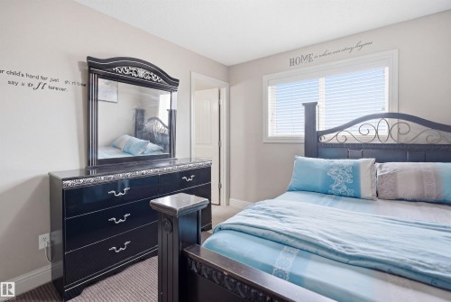 Neutral wall tones complement the window with horizontal blinds - 3533 11 Street, Edmonton, AB - Indoor Photo Showing Bedroom
