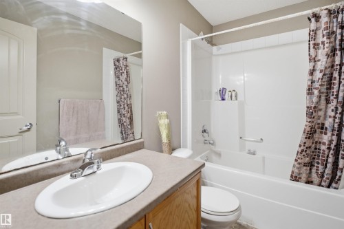 Bathroom featuring a single vanity with a laminate countertop, an undermount sink, and a chrome faucet - 3533 11 Street, Edmonton, AB - Indoor Photo Showing Bathroom