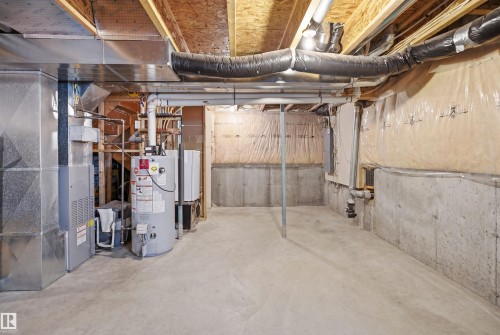 Unfinished basement space featuring concrete flooring, exposed wood joists, and concrete foundation walls - 3533 11 Street, Edmonton, AB - Indoor Photo Showing Basement
