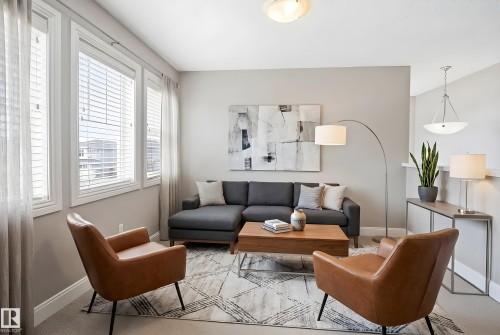 Bright interior room featuring a window with horizontal blinds, light-toned walls, and carpet flooring - 3533 11 Street, Edmonton, AB - Indoor Photo Showing Bedroom