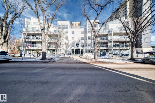 Contemporary multi-story building featuring multiple balconies with glass railings - 108 12028 103 Avenue, Edmonton, AB 