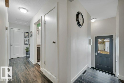 Hallway featuring dark wood-finish flooring, white walls, and recessed lighting - 7715 73 Avenue, Edmonton, AB - Indoor Photo Showing Other Room