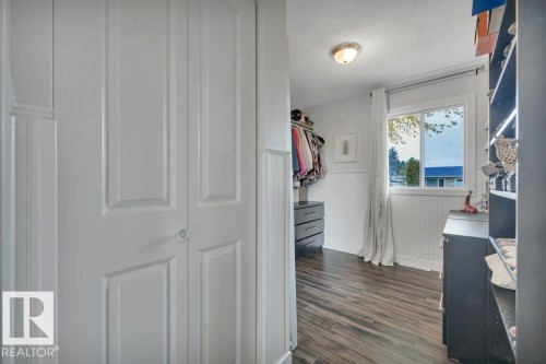 White paneled bi-fold closet doors - 7715 73 Avenue, Edmonton, AB - Indoor Photo Showing Other Room