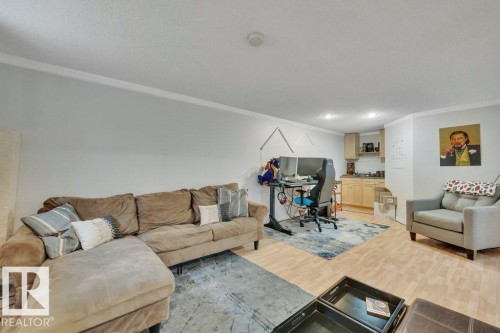 Open-concept living area with light-toned wood-finish flooring and recessed lighting - 7715 73 Avenue, Edmonton, AB - Indoor Photo Showing Living Room
