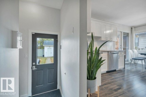 Entryway with a dark paneled door featuring a clear glass insert - 7715 73 Avenue, Edmonton, AB - Indoor Photo Showing Other Room