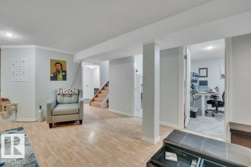 Finished lower level featuring light wood-finish flooring, recessed lighting, and crisp white trim - 7715 73 Avenue, Edmonton, AB - Indoor