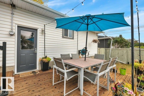 Spacious wood-finish deck with white vinyl siding exterior - 7715 73 Avenue, Edmonton, AB - Outdoor With Deck Patio Veranda With Exterior