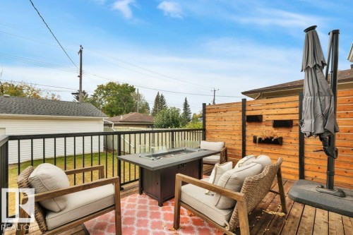 Wood deck featuring black metal railings and a privacy fence - 7715 73 Avenue, Edmonton, AB - Outdoor With Deck Patio Veranda With Exterior