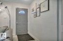 Entryway featuring a paneled door with an arched window, light-toned walls, and white trim - 7715 73 Avenue, Edmonton, AB  - Indoor Photo Showing Other Room 