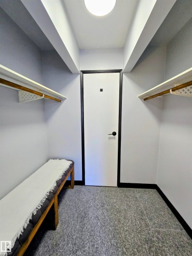 Walk-in closet featuring light gray walls, a white ceiling, recessed lighting, and gray-patterned flooring - 202 24 Alpine Place, St. Albert, AB - Indoor