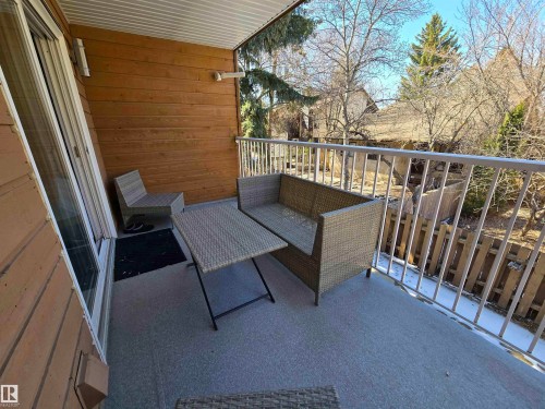 Private balcony featuring composite wood siding, a white metal railing, and a textured grey floor - 202 24 Alpine Place, St. Albert, AB - Outdoor With Deck Patio Veranda With Exterior