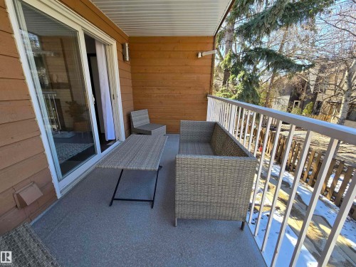 Exterior balcony featuring a sliding glass door, plank siding, and a painted metal railing - 202 24 Alpine Place, St. Albert, AB - Outdoor With Deck Patio Veranda With Exterior
