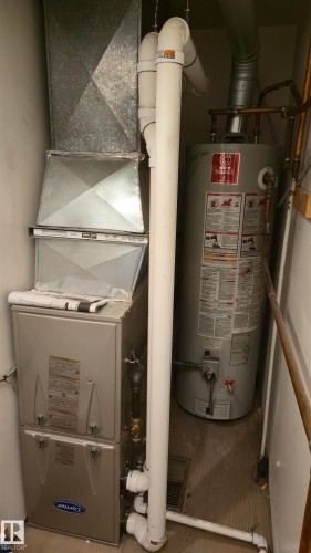 Furnace system with integrated ductwork, accompanied by a water heater and associated plumbing - 202 24 Alpine Place, St. Albert, AB - Indoor Photo Showing Basement