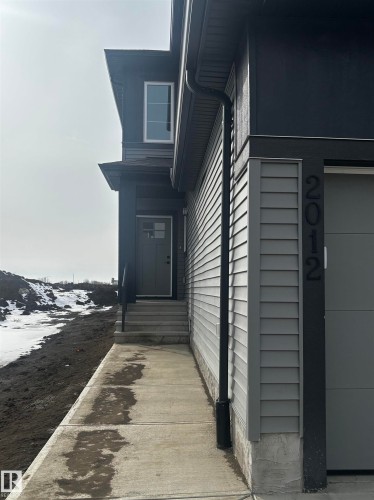 The property features a contemporary exterior with gray siding and black trim details - 2012 210 St, Edmonton, AB - Outdoor