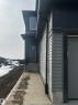 The property features a contemporary exterior with gray siding and black trim details - 2012 210 St, Edmonton, AB  - Outdoor 