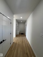 Welcoming entryway featuring light-toned flooring, white walls, and recessed lighting - 