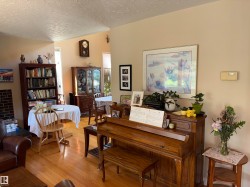 Hardwood flooring with a warm finish extends throughout the living area - 