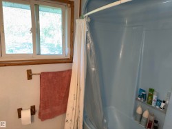 Fiberglass shower-tub combination featuring a built-in shelving unit - 