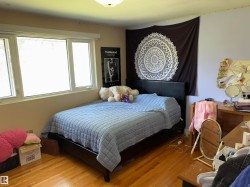 Room featuring hardwood flooring and multiple windows providing ample natural light - 