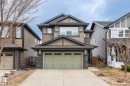 Craftsman-style exterior featuring a muted green garage door, stone pillar accents, and shake siding details - 8431 216 St Nw, Edmonton, AB  - Outdoor With Facade 