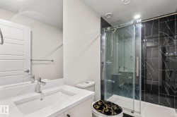 Modern bathroom featuring a single vanity with an integrated sink, polished chrome faucet, and light wood-finish cabinetry - 