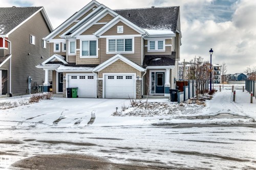 The property features a two-story exterior with light-colored siding and a dark roof - 2329 82 Street, Edmonton, AB - Outdoor With Facade