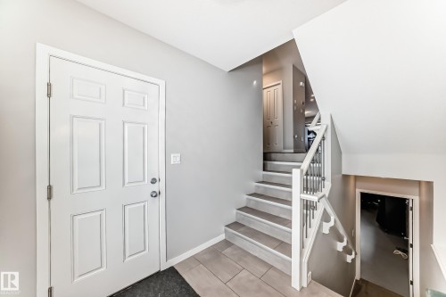 Entryway featuring a white paneled door, light grey walls, and tiled flooring - 2329 82 Street, Edmonton, AB - Indoor Photo Showing Other Room