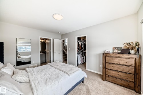 This inviting room features neutral-toned walls and plush carpeting, creating a serene atmosphere - 2329 82 Street, Edmonton, AB - Indoor Photo Showing Bedroom