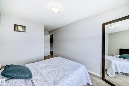 This bedroom features light gray walls, carpeted flooring, and a flush mount ceiling light - 2329 82 Street, Edmonton, AB - Indoor Photo Showing Bedroom